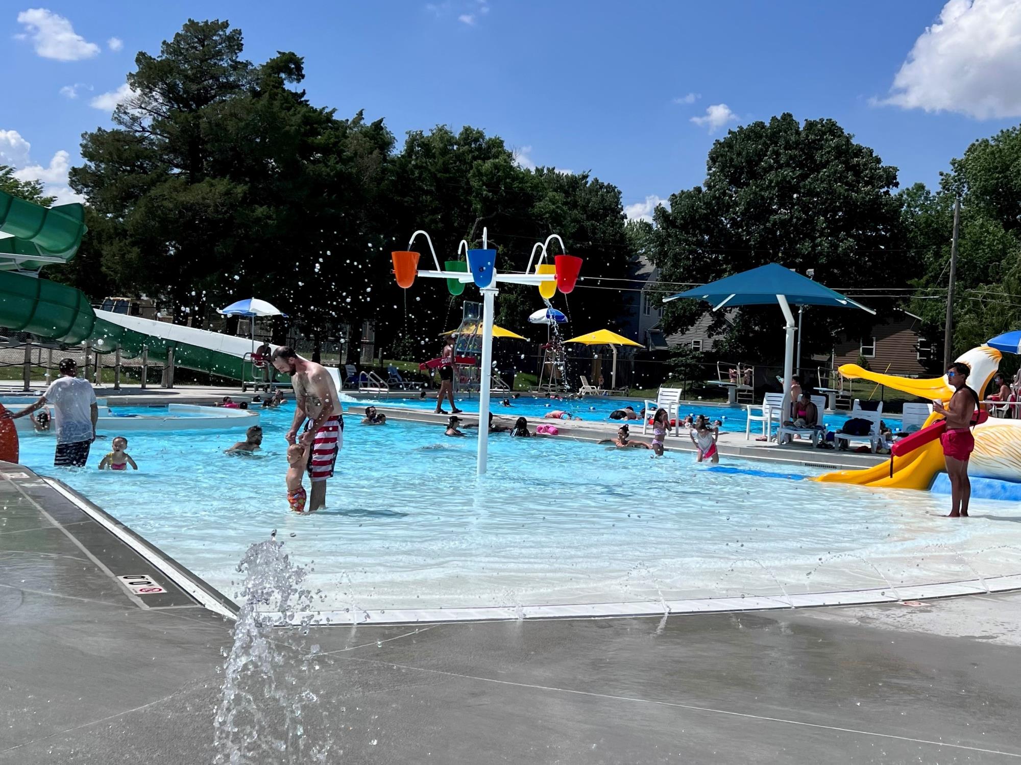 Children and families play at the pool